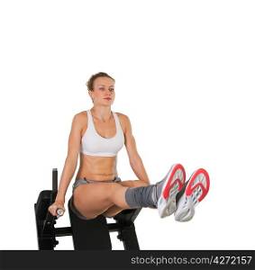 Athletic young woman training on exerciser isolated on white