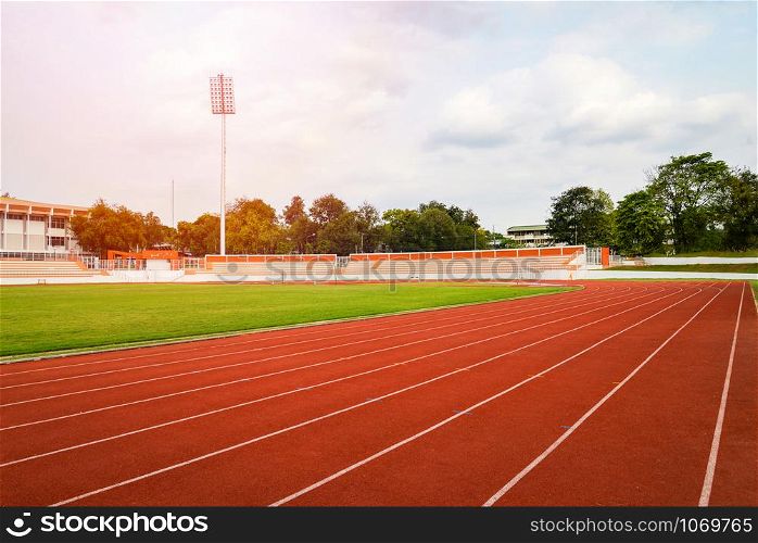 Athletics Track Run / Red running track in stadium with green field with white line in sports outdoor