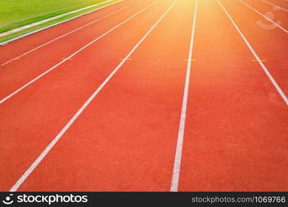 Athletics Track Run / Red running track in stadium with green field with white line in sports outdoor