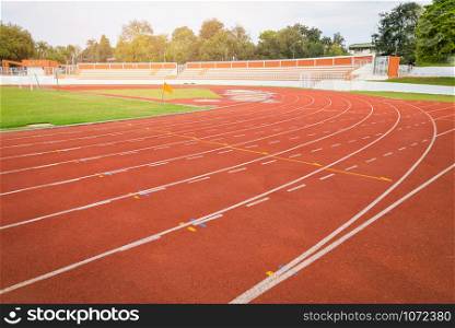 Athletics Track Run / Red running track in stadium with green field with white line in sports outdoor