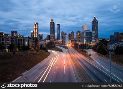 Atlanta downtown city skyline over the interstate.. Atlanta downtown modern city night skyline over the interstate, Georgia, USA.