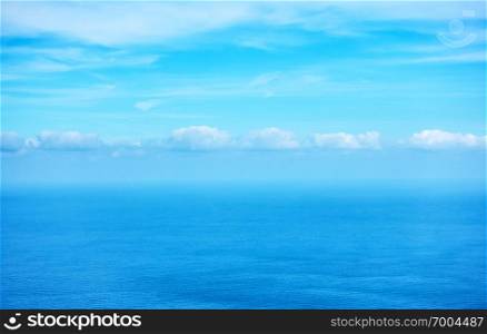 Atlantic ocean and sky - beautiful seascape with row of clouds on the horizon