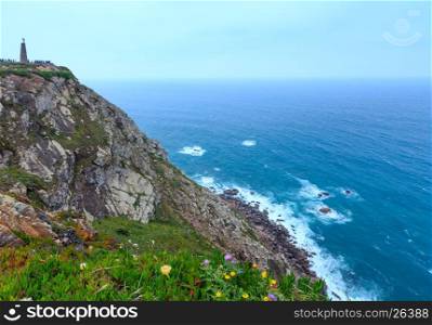 Atlantic ocean coast view in cloudy weather, Portugal. Monument declaring Cabo da Roca as the westernmost extent of continental Europe.