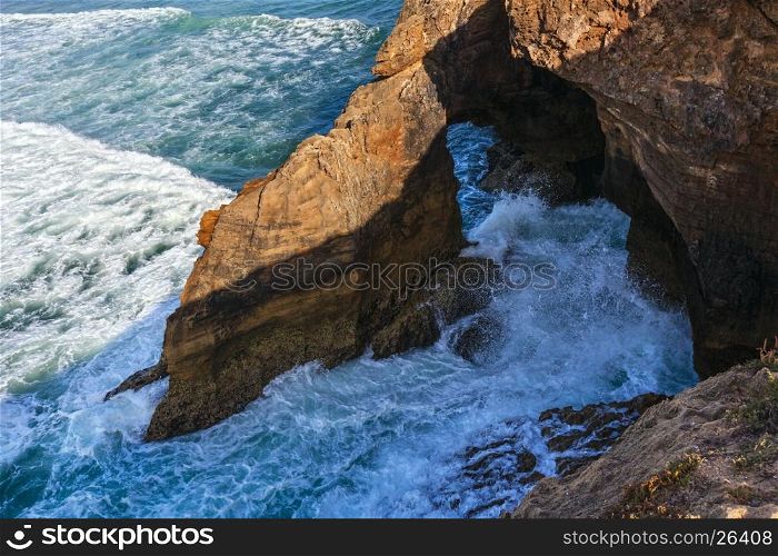 Atlantic ocean rocky coast near Amoreira beach, Portugal.
