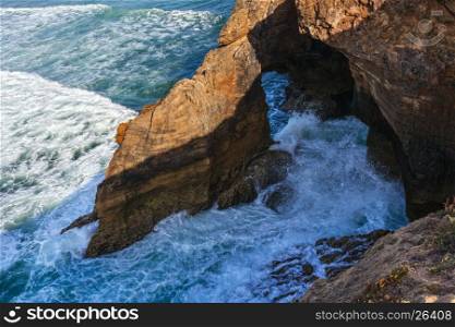 Atlantic ocean rocky coast near Amoreira beach, Portugal.