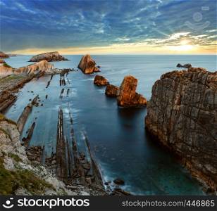 Atlantic ocean rocky coastline near Portio Beach (Pielagos, Cantabria, Spain) evening view.