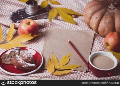 atmospheric autumn background note paper, pumpkin, apples, coffee, bun. Halloween