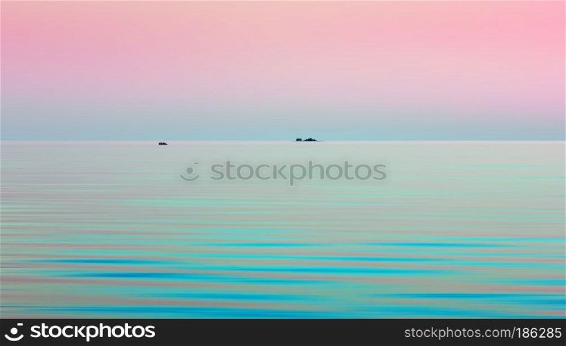 Atmospheric natural motion blurred background - turquoise waves of Onega Lake under the pink sky in the White Nights season. A small island and a boat are visible in the distance at the horizon. Space for copy.