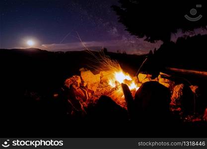 Atmospheric night around the campfire in the Black Forest with a super full moon and the Milky Way.