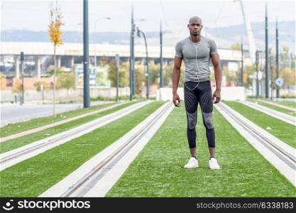 Atractive black man ready to running in urban background. Male doing workout outdoors.