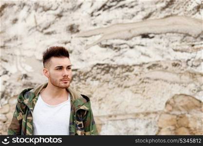 Atractive guy with jacket with military stylish in a vintage house