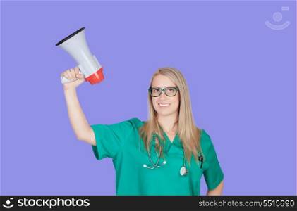 Atractive medical girl with a megaphone on a blue background