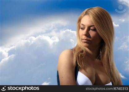 atractive sad girl on sky background