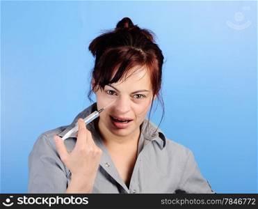 Atractive woman making a funny face injecting himself