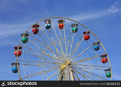 Atraktsion colorful ferris wheel against the blue sky