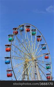 Atraktsion colorful ferris wheel against the blue sky