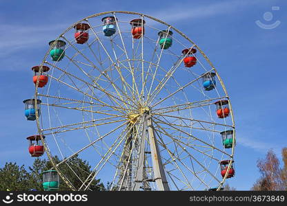 Atraktsion colorful ferris wheel against the blue sky