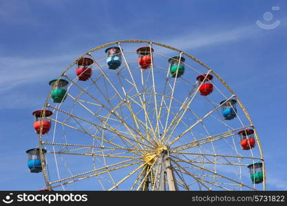 Atraktsion colorful ferris wheel against the blue sky