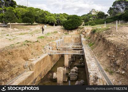 Attica, Greece - December 26, 2019: The Double-apsidal Cistern ruins, west of the Sanctuary of Hera Limenia, Greece.. The Double-apsidal Cistern west of the Sanctuary of Hera Limenia, Greece