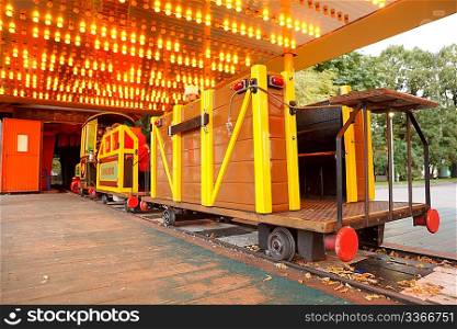 Attraction in park. Children&acute;s railway, train with bright cars.