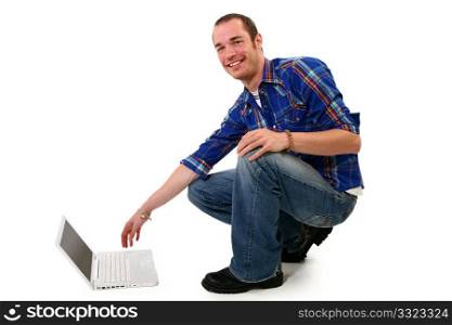 Attractive 20 something man with laptop on floor.