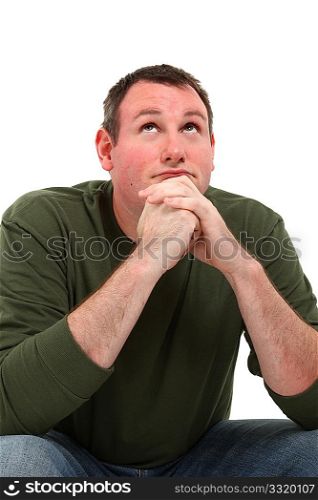 Attractive 35 year old man sitting and thinking over white background.