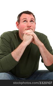 Attractive 35 year old man sitting and thinking over white background.