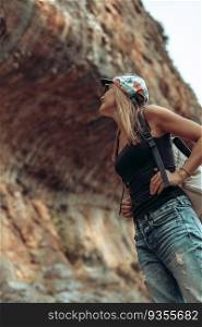 Attractive active female spending time in the mountainous park. Backpacking in summer day. Happy healthy lifestyle. Enjoying life.. Pretty woman in the mountains