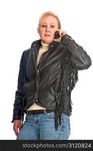 Attractive adult woman in a leather jacket talking on a cellphone. Isolated on a white background.