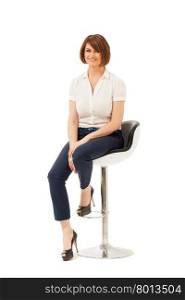 Attractive adult woman sitting on chair and looking at camera. White background, studio shot. Isolated.