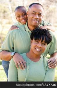 Attractive African American Man, Woman and Child posing in the park.
