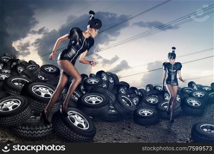 Attractive african women running on tires on the cloudy sky