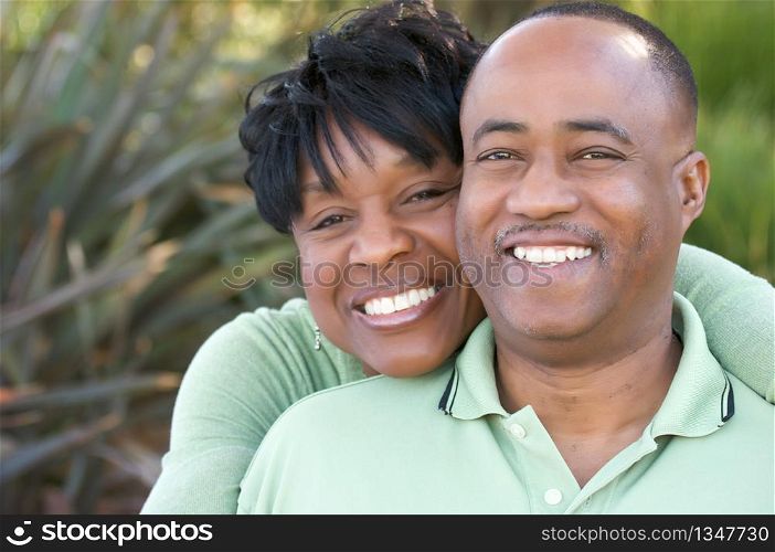 Attractive and Affectionate African American Couple posing in the park.