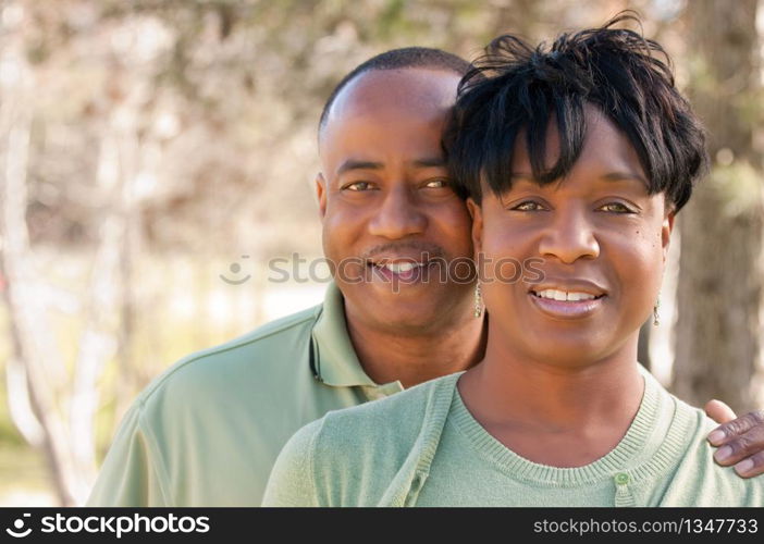 Attractive and Affectionate African American Couple posing in the park.