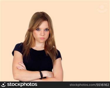 Attractive angry woman with black shirt isolated on orange background