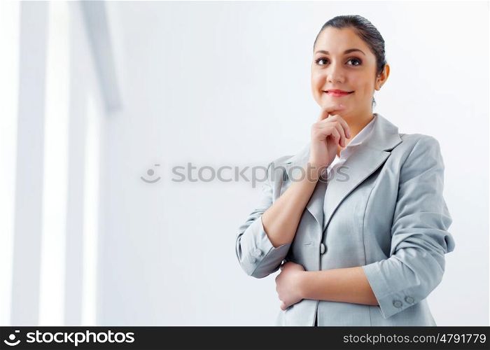 Attractive asian businesswoman in grey suit. Image of young asian businesswoman in grey suit