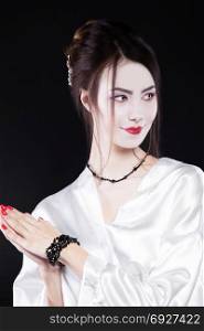 Attractive Asian girl in the image of a geisha. Beauty, fashion, portrait