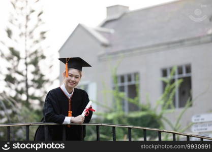 Attractive Asian Women Student Graduate in cap and gown celebrating with certificate in hand and so proud happiness in Commencement day,Congratulation of student in graduation day,Education Success