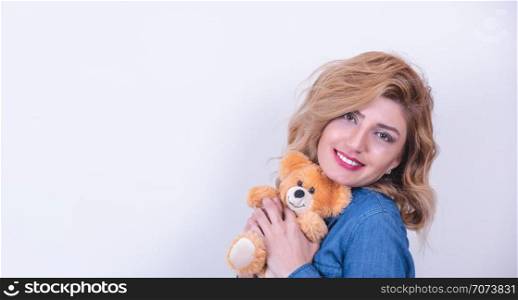Attractive beautiful model woman hugs brown teddy bear gift with isolated on white background.Concept photography