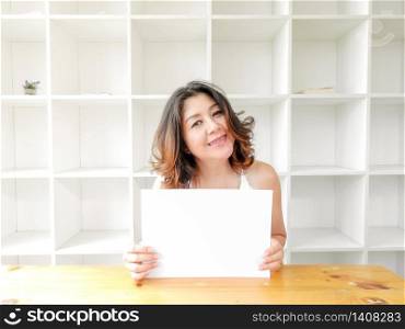 Attractive beautiful woman holding blank white paper.