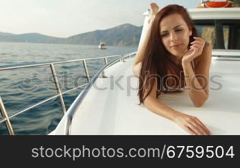 Attractive bikini woman sunbathing on luxury yacht