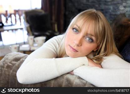 Attractive blond relaxing at home on sofa
