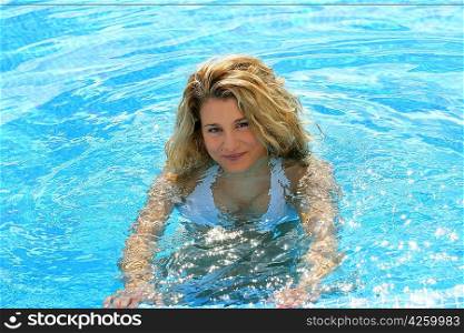 Attractive blond woman alone in swimming pool