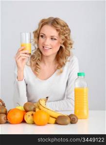 Attractive blond woman drinking orange juice