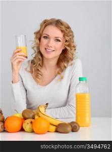 Attractive blond woman drinking orange juice