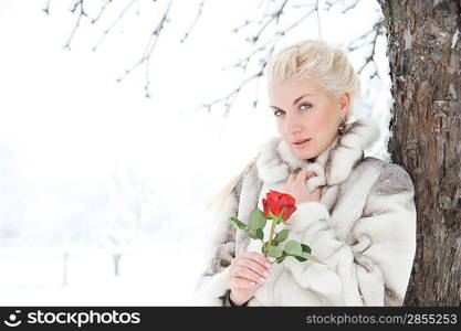 Attractive blond woman with a red rose