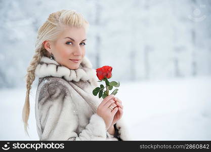 Attractive blond woman with a red rose