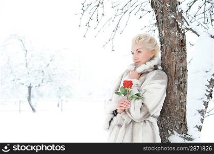 Attractive blond woman with a red rose