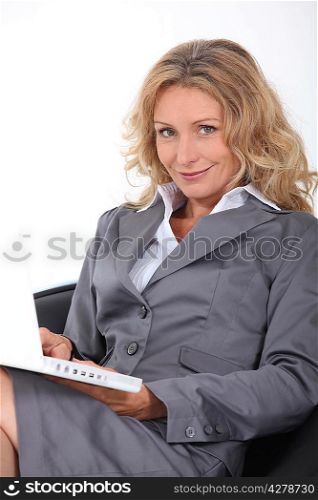 Attractive blonde haired woman using a laptop computer