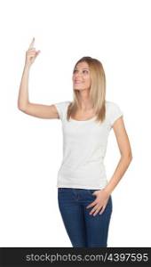 Attractive blonde pointing something with her finger isolated on a white background